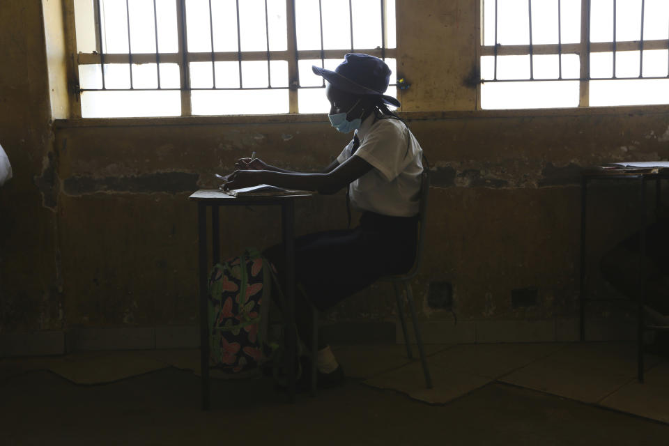 A student attends a class at a school in Harare, Monday, Sept, 28, 2020. Zimbabwe schools have reopened in phases, but with smaller number of pupils,more teachers and other related measures to enable children to resume their education without the risk of a spike in COVID-19 infections. (AP Photo/Tsvangirayi Mukwazhi)