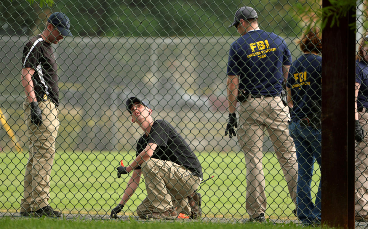 FBI technicians examine a baseball field where shots were fired during a congressional baseball practice in Alexandria, Va., June 14, 2017. (Mike Theiler/Reuters)