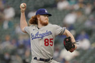 Los Angeles Dodgers starting pitcher Dustin May throws against the Seattle Mariners during the first inning of a baseball game, Monday, April 19, 2021, in Seattle. (AP Photo/Ted S. Warren)