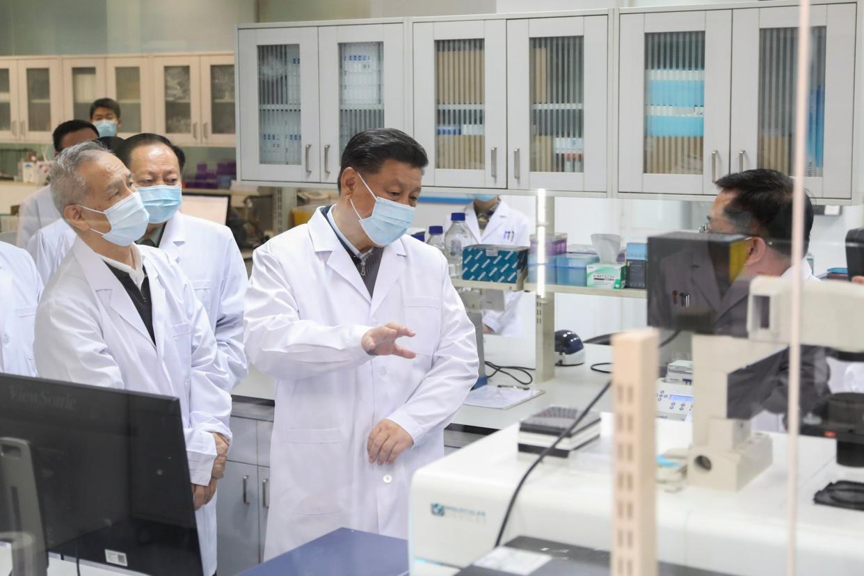 Chinese president Xi Jinping is seen talking to medical staff during a visit to the Academy of Military Medical Sciences in Beijing on Monday: AP