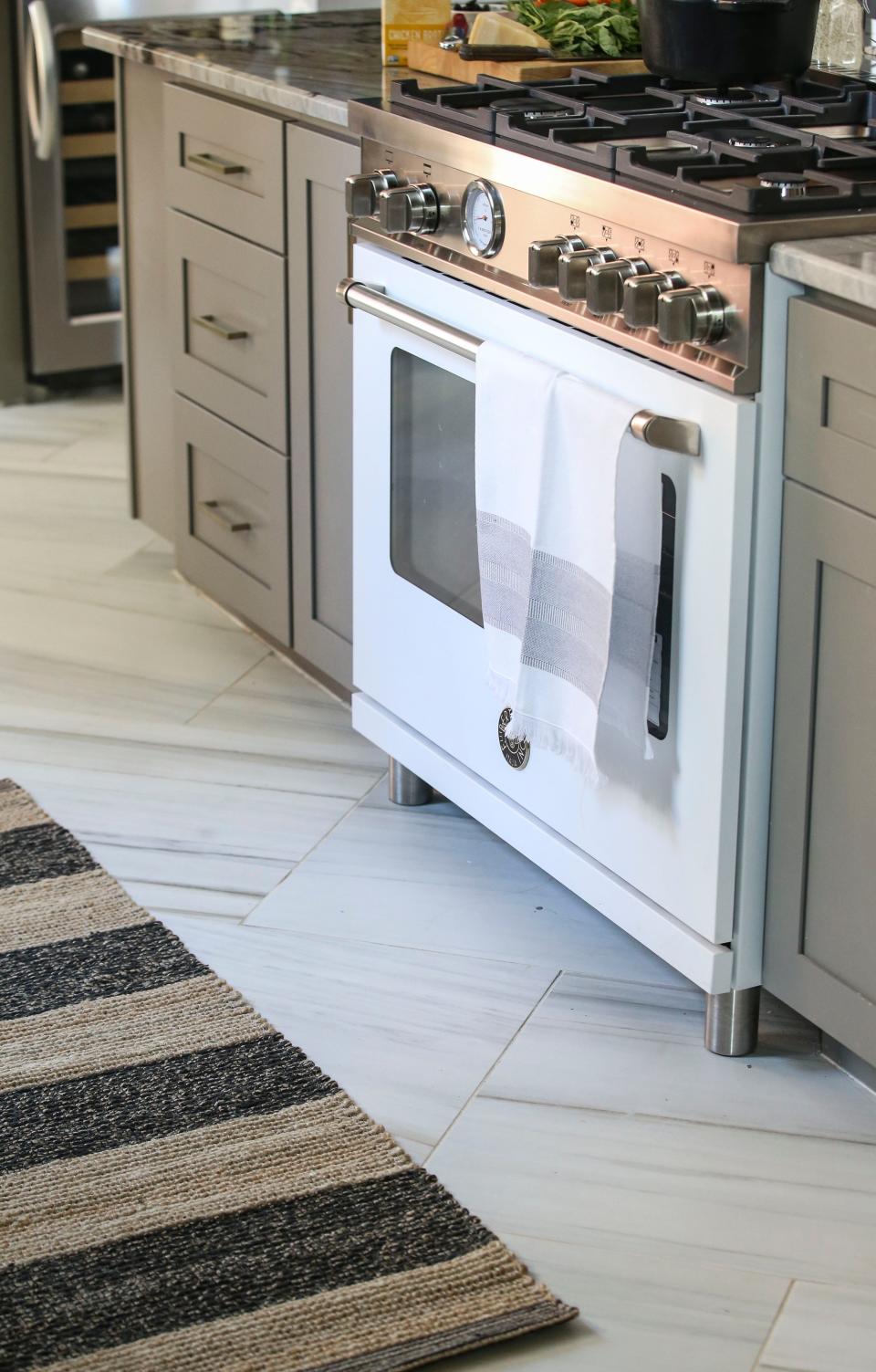 The matte white finish on the 36-inch Bertazzoni Master Series range is an elegant statement against the deep blue walls on this renovated kitchen in Louisville's Beechmont neighborhood.