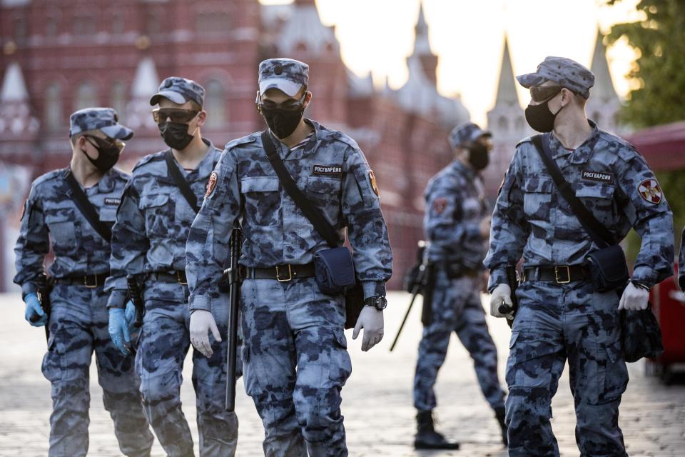 Russian Rosguardia (National Guard) soldiers wearing face masks and gloves to protect against coronavirus, guard an area on Red Square before a rehearsal of the military parade near Red Square in Moscow, Russia, Sunday, June 14, 2020. Last month, Putin ordered an end to the nationwide economic shutdown and set dates for the two main events on his agenda that were postponed due to the coronavirus. (AP Photo/Alexander Zemlianichenko)