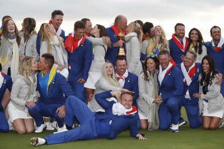 Golf - 2018 Ryder Cup at Le Golf National - Guyancourt, France - September 30, 2018. Team Europe players celebrate with the trophy and their wives and girlfriends after winning the Ryder Cup REUTERS/Paul Childs