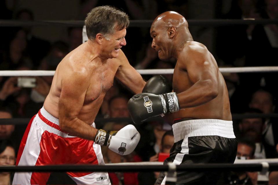 Mitt Romney fights five-time heavyweight champion Evander Holyfield during their boxing match in Salt Lake City, Utah