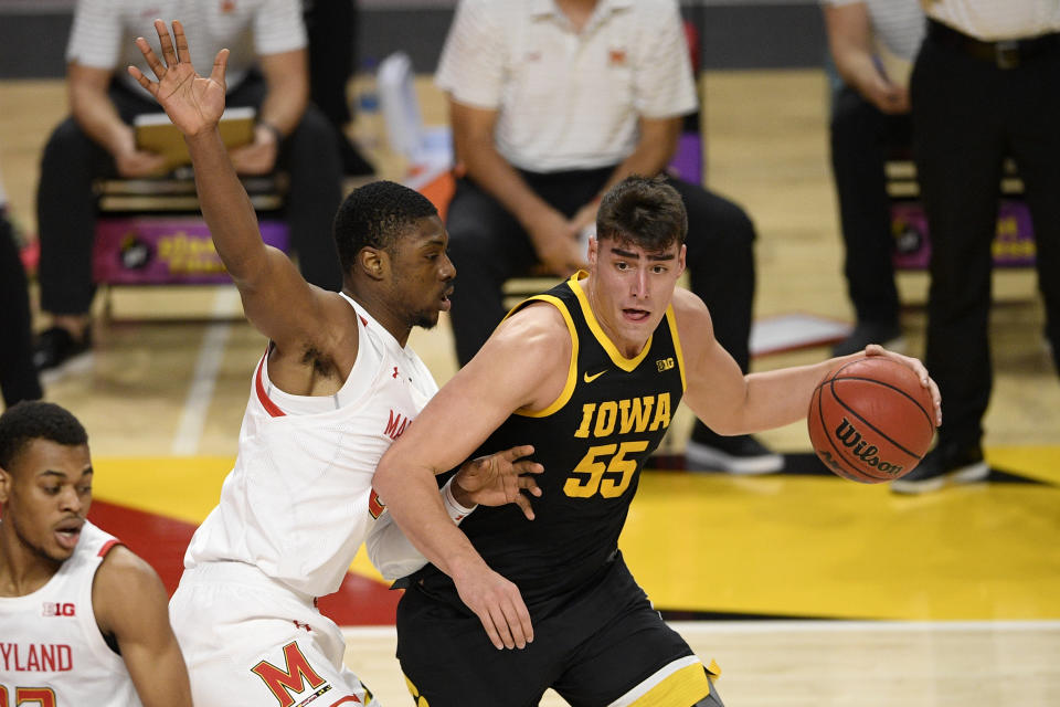 Iowa center Luka Garza (55) dribbles next to Maryland forward Jairus Hamilton, left, during the first half of an NCAA college basketball game, Thursday, Jan. 7, 2021, in College Park, Md. (AP Photo/Nick Wass)