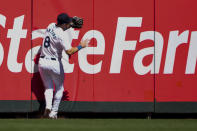 Seattle Mariners left fielder Dominic Canzone collides with the wall after catching a fly ball hit by Chicago Cubs' Mike Tauchman during the second inning of a baseball game Sunday, April 14, 2024, in Seattle. Canzone would leave the game due to injury after the play. (AP Photo/Lindsey Wasson)