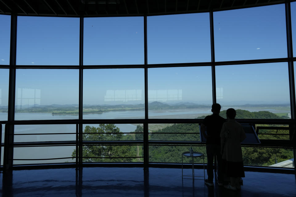 Visitors look at the North Korea side from the unification observatory in Paju, South Korea, Thursday, Sept. 8, 2022. South Korea's new government on Thursday proposed a meeting with North Korea to resume reunions of families separated since the 1950-53 Korean War, despite long-strained ties between the rivals over the North's nuclear weapons program. (AP Photo/Lee Jin-man)