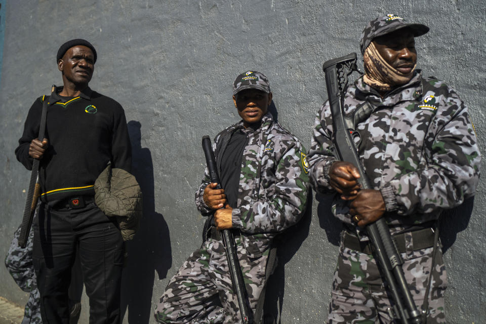 Private South African security officers guard the scene of one of South Africa's deadliest inner-city fires in Johannesburg, South Africa, Friday, Sept. 1, 2023. Emergency services teams have left the scene of one of South Africa's deadliest inner-city fires as pathologists faced the grisly task Friday of identifying dozens of charred bodies and some separate body parts that had been transported to several mortuaries across the city of Johannesburg. (AP Photo/Jerome Delay)