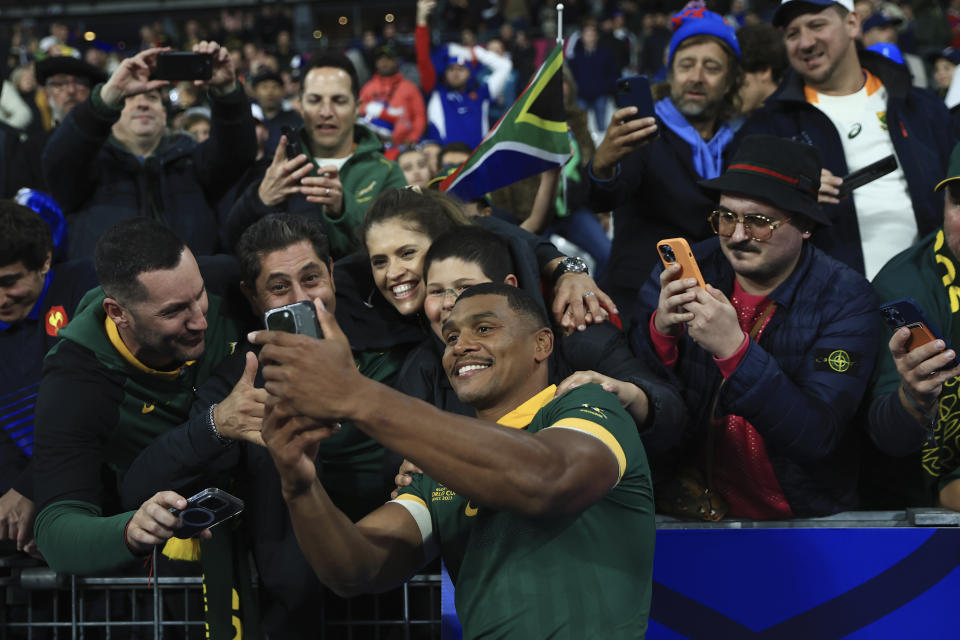 South Africa's Damien Willemse celebrates with fans after winning the Rugby World Cup quarterfinal match between France and South Africa at the Stade de France in Saint-Denis, near Paris, Sunday, Oct. 15, 2023. South Africa won 29-28. (AP Photo/Aurelien Morissard)