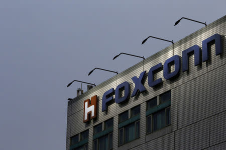 FILE PHOTO: The logo of Foxconn, the trading name of Hon Hai Precision Industry, is seen on top of the company's headquarters in New Taipei City, Taiwan March 29, 2016. REUTERS/Tyrone Siu/File Photo