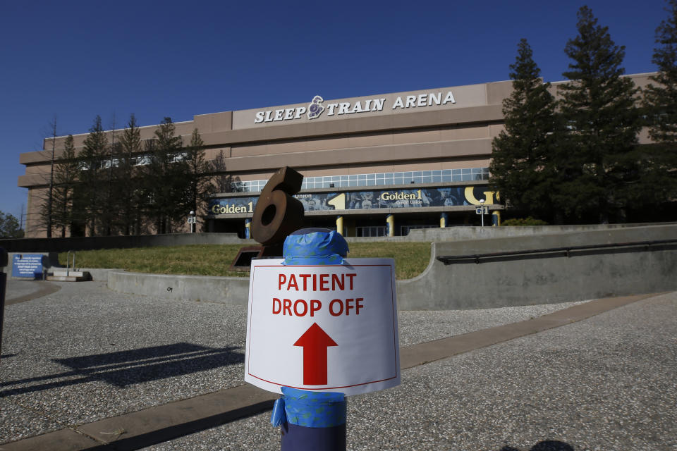 FILE - In this April 18, 2020, file photo, a temporary sign is placed at Sleep Train Arena that has been turned into a 400-bed emergency field hospital to help deal with the coronavirus, in Sacramento, Calif. California spent nearly $200 million to set up, operate and staff alternate care sites that ultimately provided little help when the state’s worst coronavirus surge spiraled out of control last winter, forcing exhausted hospital workers to treat patients in tents and cafeterias. (AP Photo/Rich Pedroncelli, Pool, File)