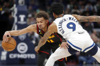 Minnesota Timberwolves guard Nickel Alexander-Walker (9) fouls Atlanta Hawks guard Trae Young (11) as he dribbles past in the third quarter of an NBA basketball game Wednesday, March 22, 2023, in Minneapolis. The Timberwolves won 125-124. (AP Photo/Bruce Kluckhohn)