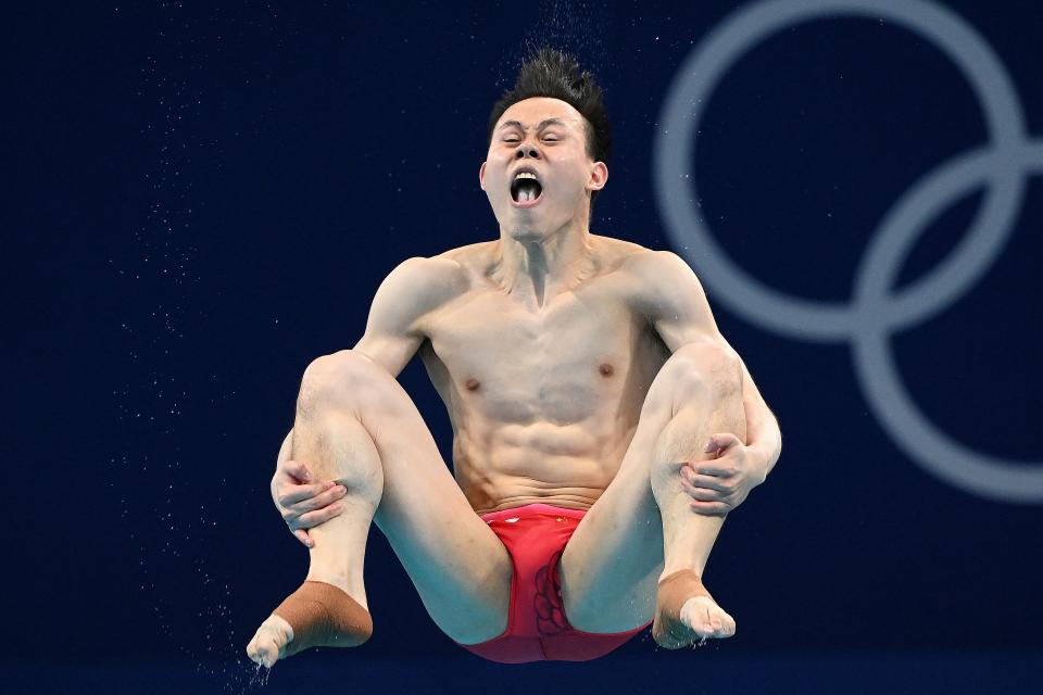 <p>TOPSHOT - China's Xie Siyi competes to win the men's 3m springboard diving final event during the Tokyo 2020 Olympic Games at the Tokyo Aquatics Centre in Tokyo on August 3, 2021. (Photo by Attila KISBENEDEK / AFP) (Photo by ATTILA KISBENEDEK/AFP via Getty Images)</p> 