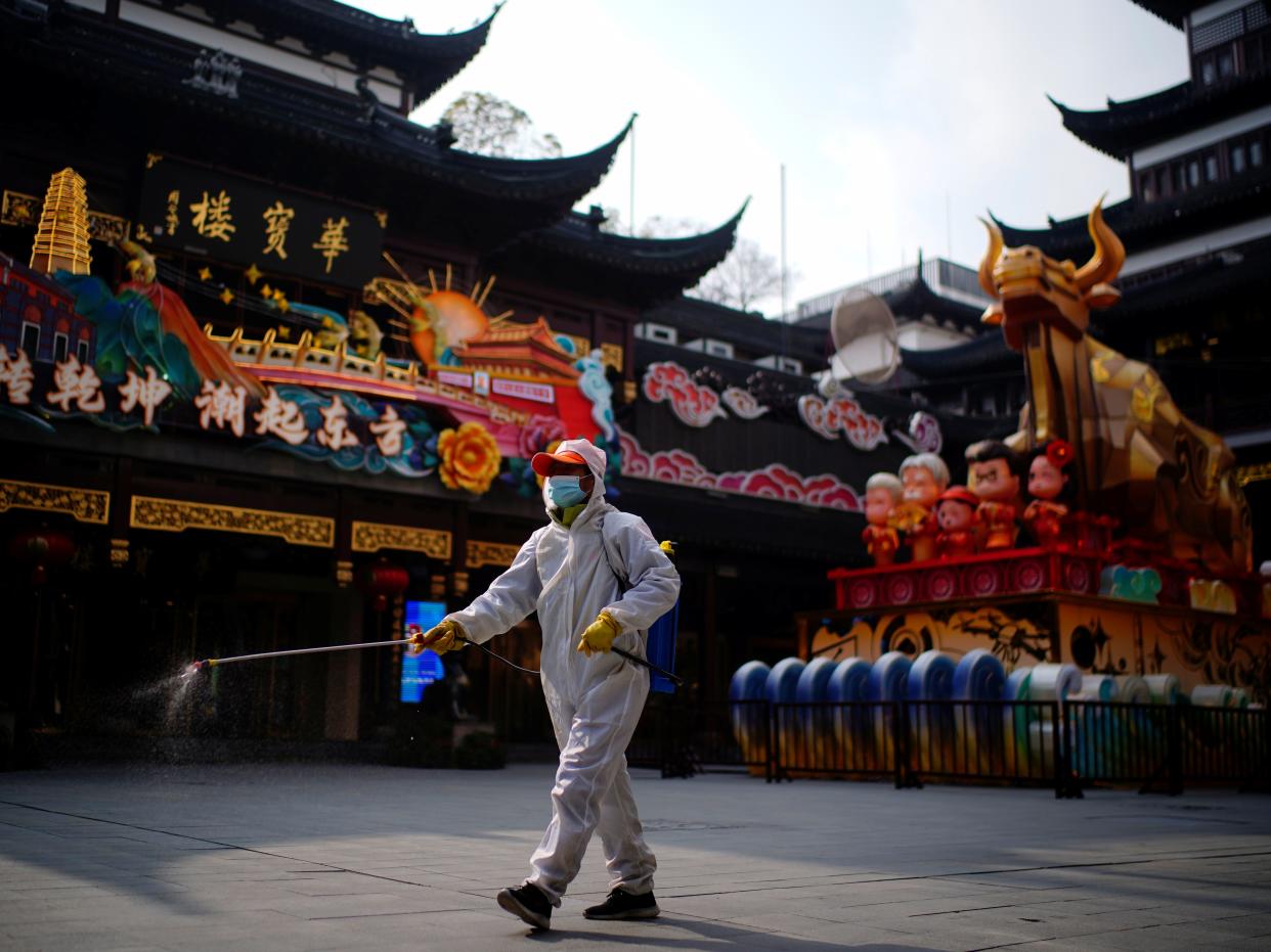 <p>A worker disinfects Yuyuan, or Yu Garden, near an ox installation set up ahead of the Chinese Lunar New Year festivity, following the coronavirus disease (COVID-19) outbreak in Shanghai</p> (Reuters)