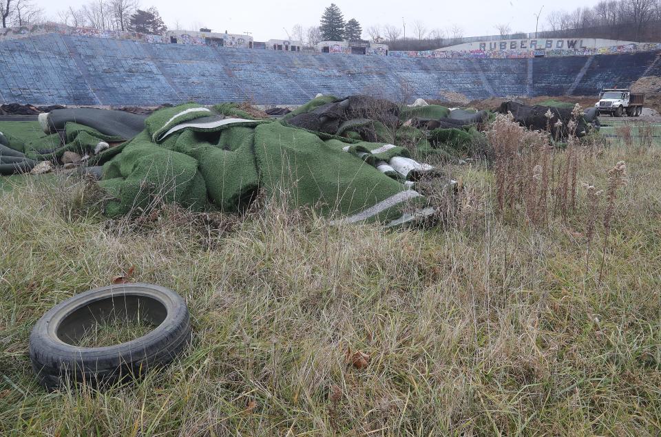Trash and debris are strewn around the Rubber Bowl. The city has agreed to tear down what's left of the structure and make it a hillside.