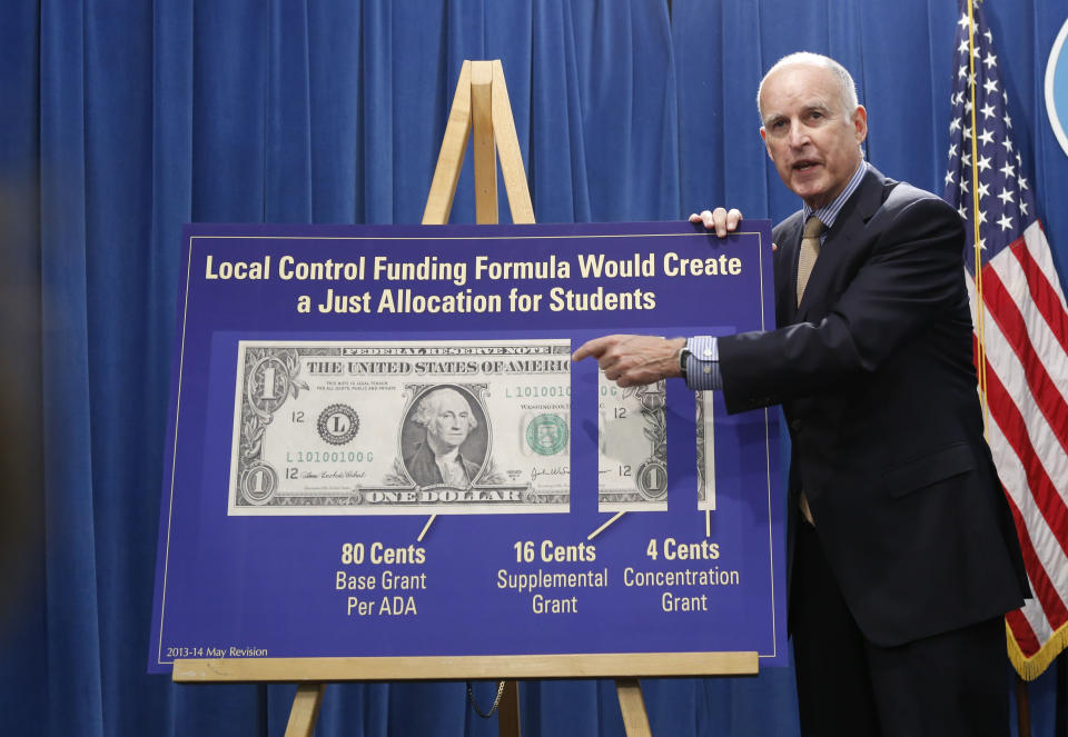 FILE -- In this May 14, 2013 file photo, Gov. Jerry Brown gestures to a chart showing his plan to give more local control over education funding as he discussed his updated 2013-14 state budget plan at the Capitol in Sacramento, Calif. In his second stint as California's chief executive, Brown has received wide praise for bringing the state's massive budget deficit into line and enters the final year of his third term with a 58 percent approval rating.(AP Photo/Rich Pedroncelli, File)