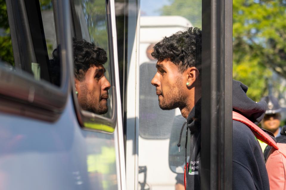 A person is seen boarding a bus.