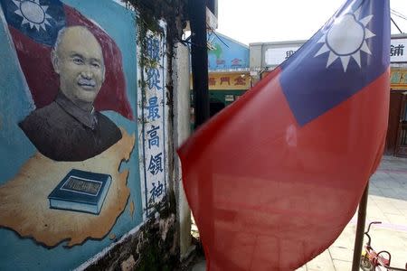 A mural of Taiwan's late president Chiang Kai-shek is seen close to a Taiwan national flag in Kinmen county, Taiwan, September 8, 2015. REUTERS/Pichi Chuang