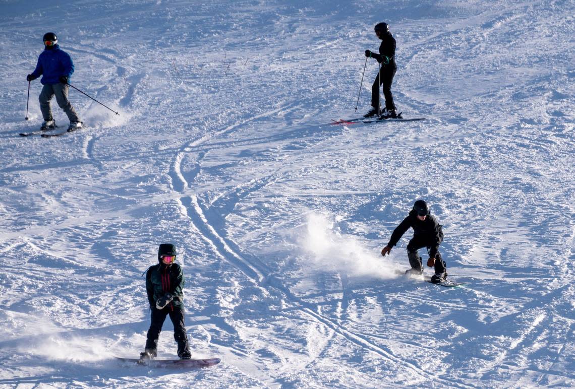 Skiers and snowboarders go down a run at Palisades Tahoe on Thursday, Jan. 11, 2024, a day after a deadly avalanche buried multiple people and killed a 66-year-old man.