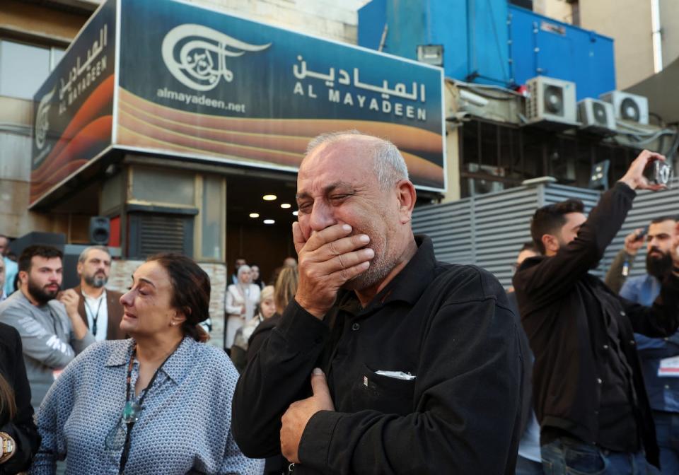 Colleagues of the two journalists of Lebanon-based Al Mayadeen TV channel, who it says were killed by an Israeli strike in southern Lebanon, mourn as they stand outside the channel's building in Beirut, Lebanon, on Nov. 21, 2023. 