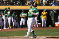 Oakland Athletics' Seth Brown, right, looks up as he crosses home plate after hitting a solo home run against the New York Mets during the third inning of a baseball game in Oakland, Calif., Saturday, Sept. 24, 2022. (AP Photo/Tony Avelar)