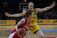 Japan's Saori Miyazaki runs past Australia's Darcee Garbin during their game at the women's Basketball World Cup in Sydney, Australia, Tuesday, Sept. 27, 2022. (AP Photo/Mark Baker)