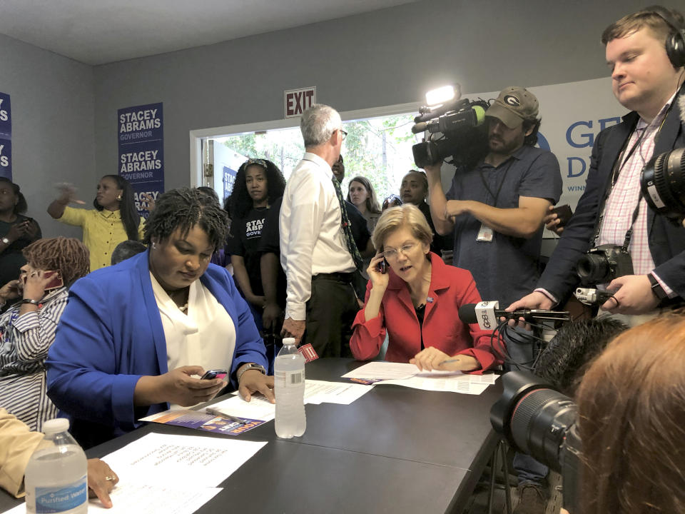 Georgia Democratic gubernatorial candidate Stacey Abrams, left, and Sen. Elizabeth Warren, a Democrat, right, call voters on Tuesday to rally support for Abrams in Jonesboro, Ga. (Photo: Ben Nadler/AP)