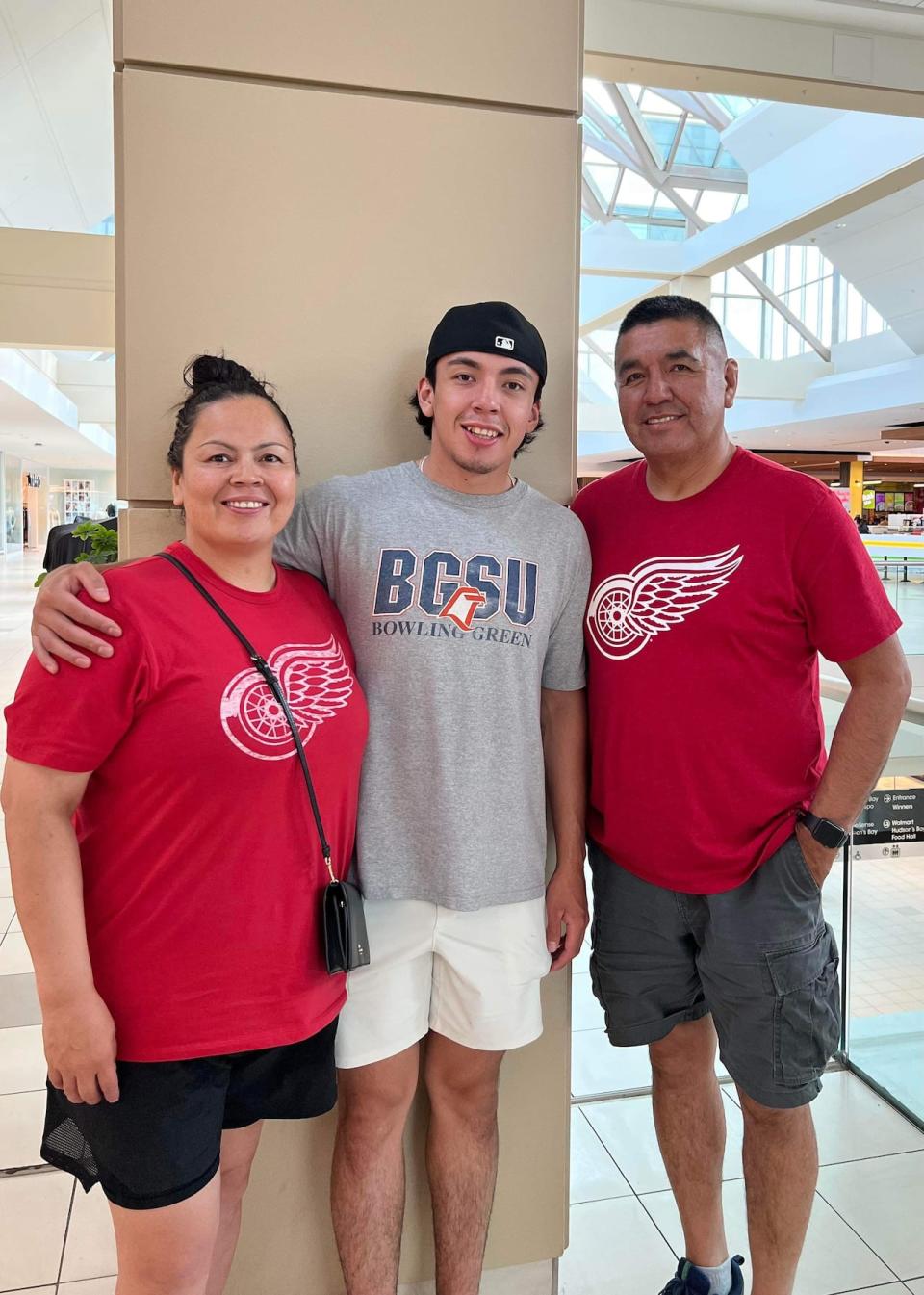 Israel Mianscum, centre, stands with parents Tiffany and Louie, while attending a development camp earlier this summer with the Detroit Red Wings. The 20-year-old has been invited to attend this year's NHL Prospects Tournament and the Red Wings' development camp in Sept.