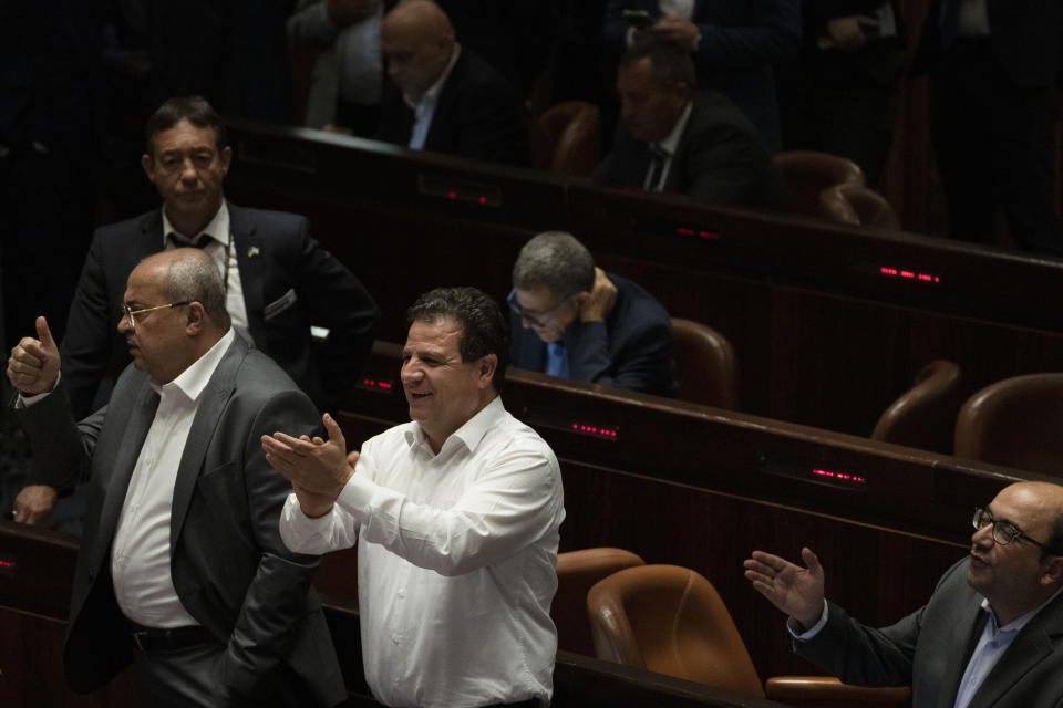 Arab lawmakers celebrate the defeat of a law on the legal status of Jewish settlers in the occupied West Bank, during a session of the Knesset, Israel's parliament, in Jerusalem, Monday, June 6, 2022. (AP Photo/ Maya Alleruzzo)