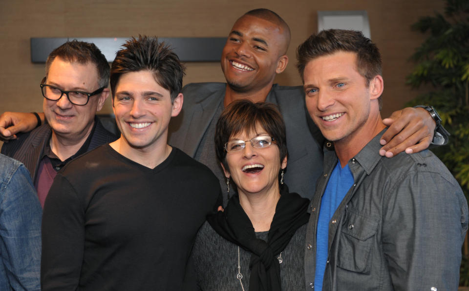 Jill Farren Phelps, second from right, executive producer of "The Young and the Restless," poses with, from left, the show's head writer Josh Griffith and cast members Robert Adamson, Redaric Williams and Steve Burton at the Hot New Faces of "The Young and the Restless" press junket at CBS Television City on Wednesday, Feb. 27, 2013 in Los Angeles. The CBS show, daytime's top-rated soap since December 1988, hits the big 4-0 on Tuesday, March 26, 2013. (Photo by Chris Pizzello/Invision/AP)