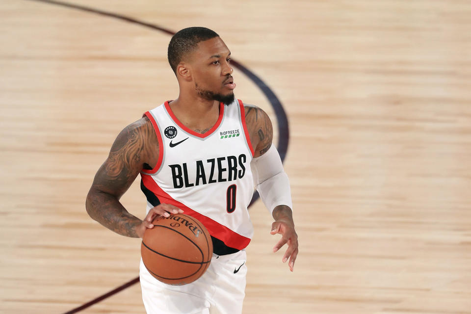 Portland Trail Blazers' Damian Lillard dribbles during the first half of an NBA basketball game against the Memphis Grizzlies, Friday, July 31, 2020, in Lake Buena Vista, Fla. (Mike Ehrmann/Pool Photo via AP)