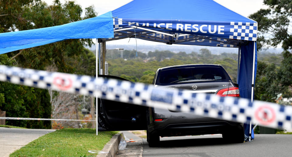 Photo of a police car outside a Sydney home following the stabbing of a five-year-old.