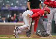 Cincinnati Reds' Nick Senzel reacts after scoring on a wild pitch thrown by Colorado Rockies relief pitcher Jordan Sheffield in the ninth inning of a baseball game Sunday, May 16, 2021, in Denver. (AP Photo/David Zalubowski)