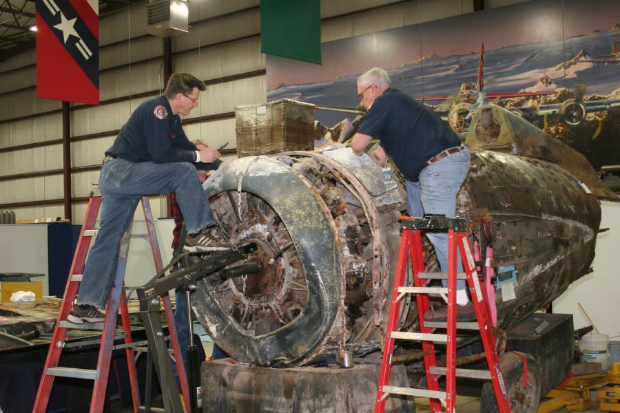 Volunteers work on the Wildcat. (Air Zoo)