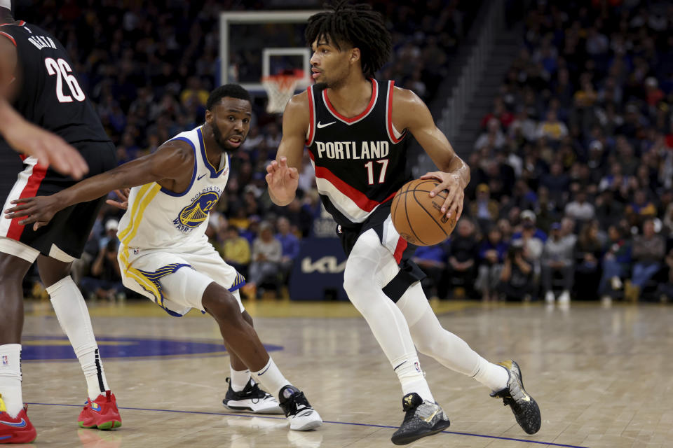 Portland Trail Blazers guard Shaedon Sharpe (17) drives against Golden State Warriors forward Andrew Wiggins (22) during the first half of an NBA basketball game in San Francisco, Wednesday, Dec. 6, 2023. (AP Photo/Jed Jacobsohn)