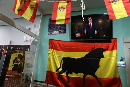 Spanish flags are are seen next to a TV screen showing Spanish Prime Minister and Socialist Worker's Party candidate Pedro Sanchez during a live televised debate ahead of general elections in Madrid, Spain, April 22, 2019. REUTERS/Susana Vera