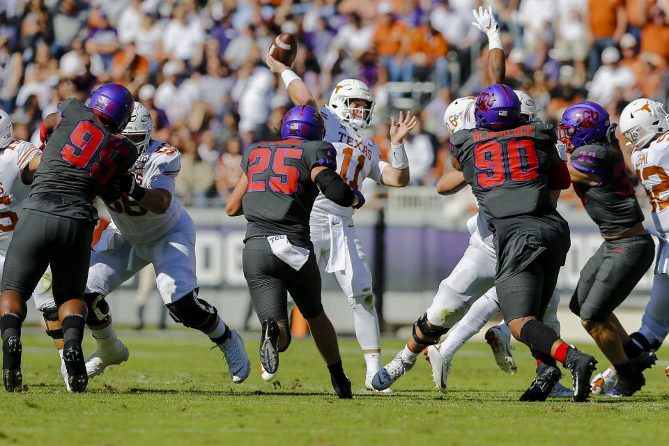 FORT WORTH, TX - OCTOBER 26: Texas Longhorns quarterback Sam Ehlinger (11) looks downfield for an open receiver as TCU Horned Frogs defensive end Wyatt Harris (25) rushes in during the game between the TCU Horned Frogs and the Texas Longhorns on October 26, 2019 at Amon G. Carter Stadium in Fort Worth, Texas. (Photo by Matthew Pearce/Icon Sportswire via Getty Images)