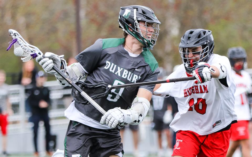 Duxbury's Zachary Falls is defended by Hingham's Brad Lee during a game at Hingham High School on Tuesday, April 30, 2024.