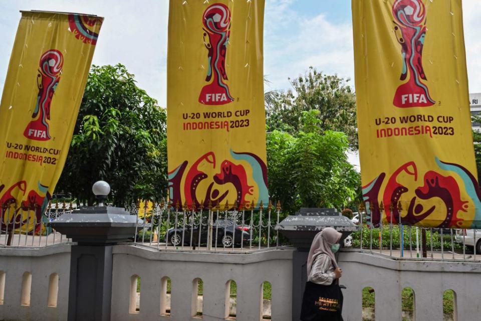 A woman walks past banners for the Under-20 World Cup after Indonesia's hosting of the tournament was revoked, in Jakarta on March 30, 2023.<span class="copyright">Adek Berry—AFP/Getty Images</span>