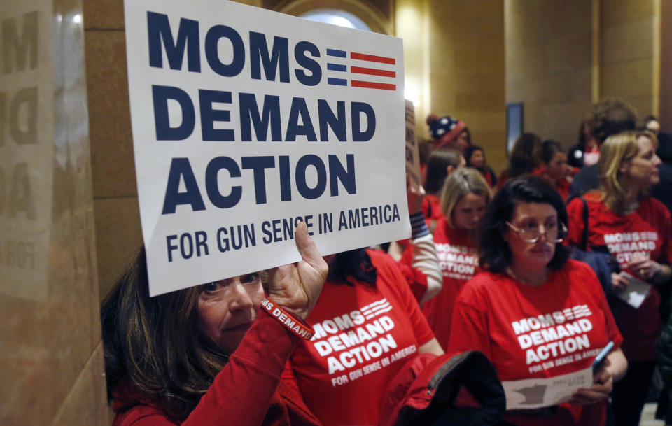 <p>Connie Ortberg, left, holds her sign as women rally at the Minnesota State Capitol Tuesday, Feb. 20, 2018, as the 2018 legislative gets underway in St. Paul, Minn., as Moms Demand Actions called on lawmakers to expand background checks and resist efforts to widen the state’s gun laws after the school shooting in Florida last week. (Photo: Jim Mone/AP) </p>