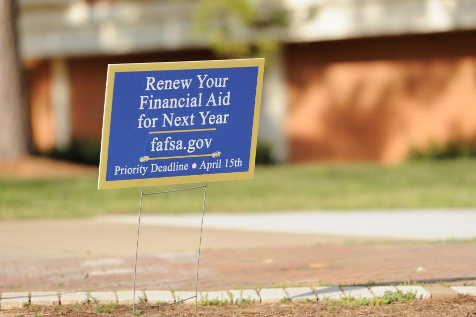 Americus, Georgia, USA - March 13, 2016:  Yard sign encouraging students to renew financial aid for next year, with the web site fafsa.gov.  Priority deadline of April 15th.  Sign placed on campus of Georgia Southwestern State University campus, a public university in Americas, Georgia, near the library.