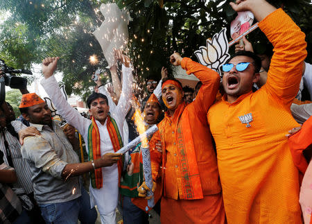 BJP supporters celebrate after learning the initial election results outside the party headquarters in New Delhi, India, May 23, 2019. REUTERS/Adnan Abidi