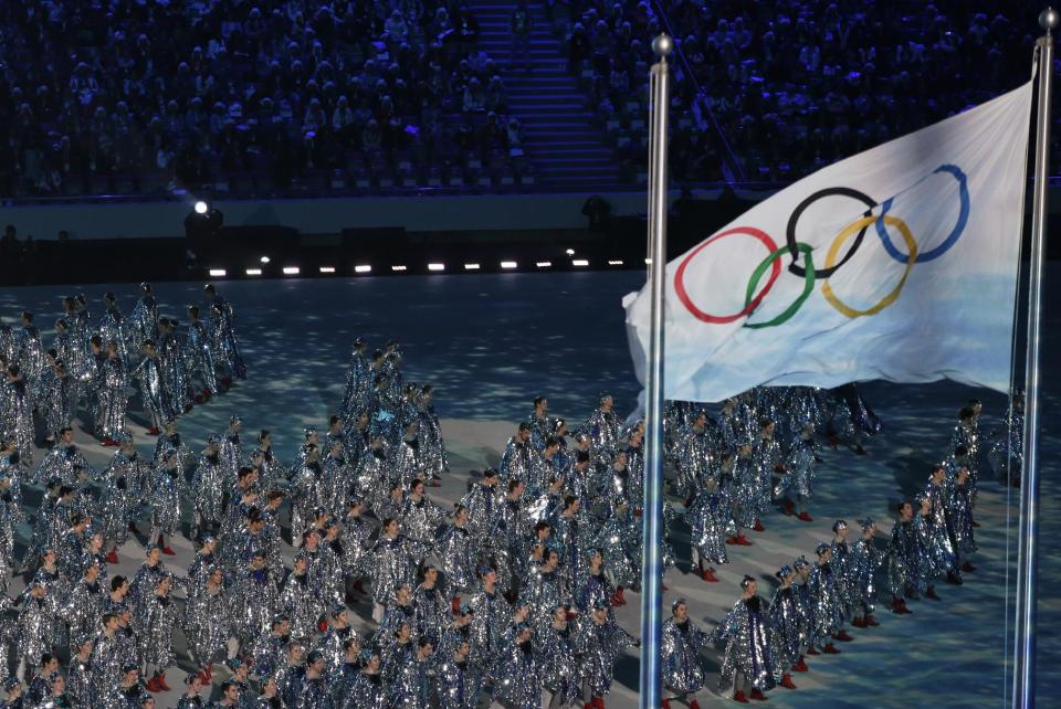 Artists perform near the Olympic Flag during the closing ceremony of the 2014 Winter Olympics, Sunday, Feb. 23, 2014, in Sochi, Russia. (AP Photo/Gregorio Borgia)