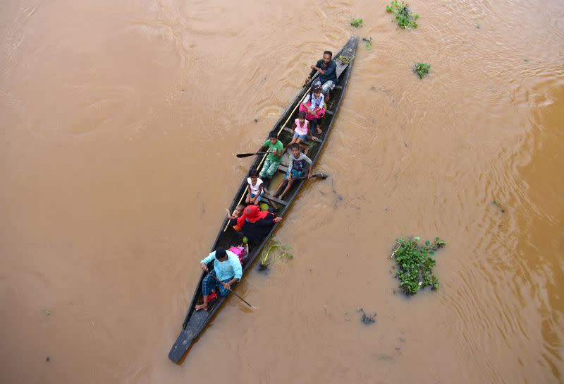 FILE PHOTO: Flood-affected villagers are transported by boat to safety at Kachua village