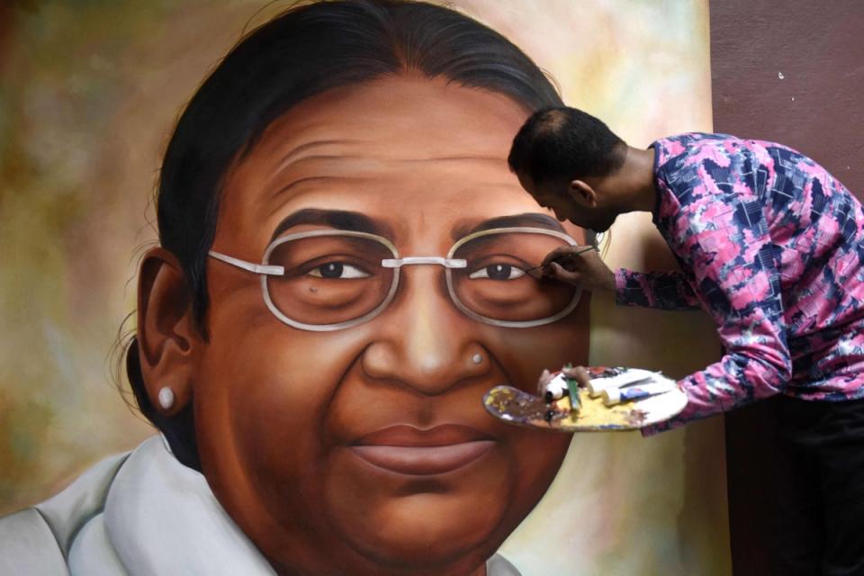 Jagjot Singh Rubal gives final touches to a painting of Bharatiya Janata Party’s (BJP) presidential candidate, Droupadi Murmu, in Amritsar (AFP via Getty)