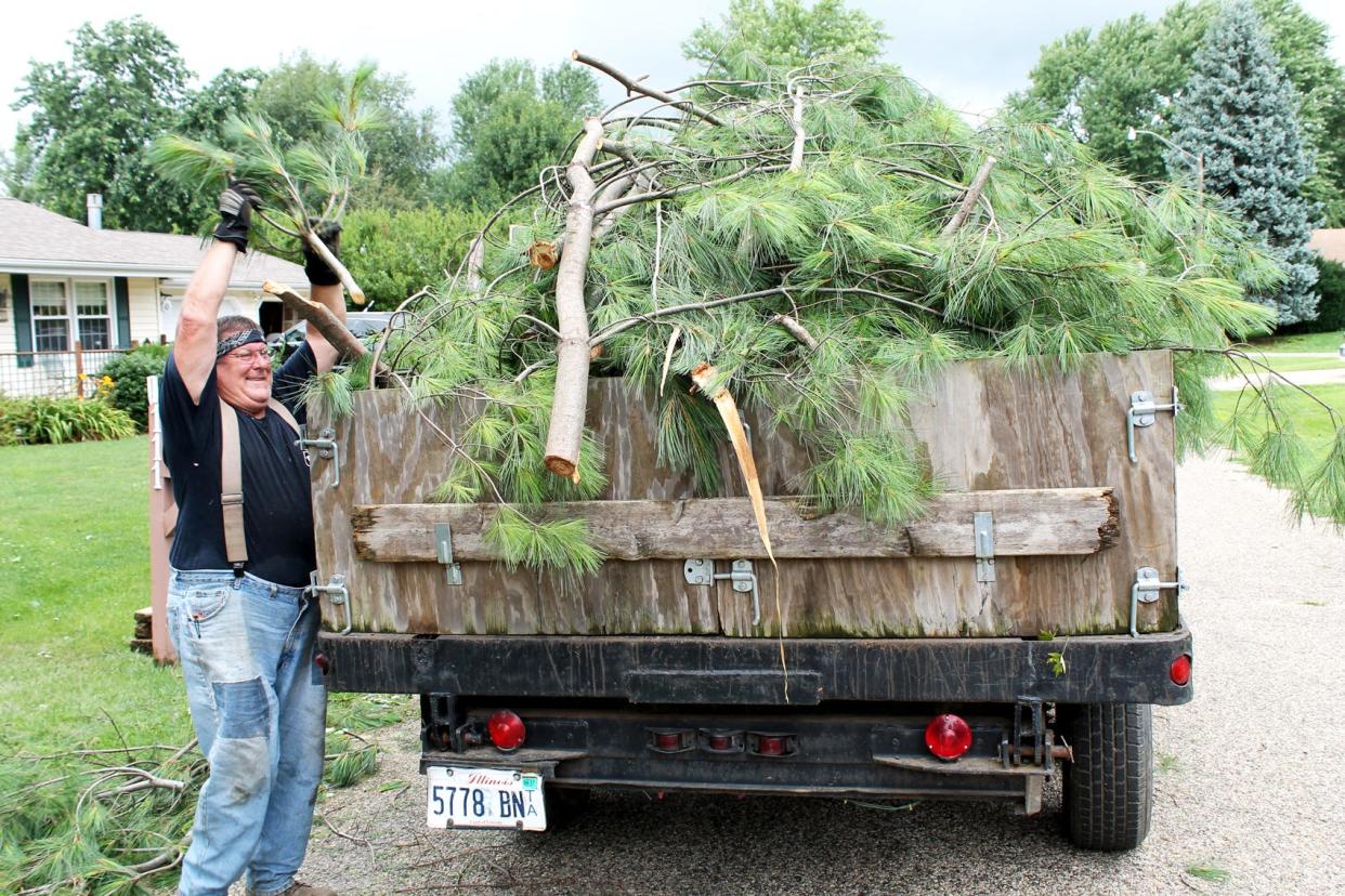 In this file photo, Frank Scott of Green Valley hauls away debris after a storm blew through and knocked out power to a majority of residents in the southern Tazewell County town.
(Photo: Pekin Daily Times)