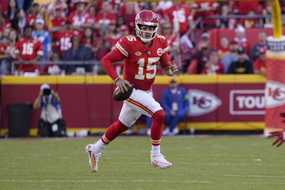 Kansas City Chiefs quarterback Patrick Mahomes scrambles into open field.