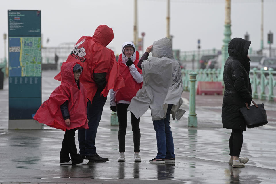 People brave the wind as Storm Ciaran brings high winds and heavy rain along the south coast of England, in Brighton, England, Thursday, Nov. 2, 2023. Winds up to 180 kilometers per hour (108 mph) slammed France's Atlantic coast overnight as Storm Ciaran lashed countries around western Europe, uprooting trees, blowing out windows and leaving 1.2 million French households without electricity Thursday. Strong winds and rain also battered southern England and the Channel Islands, where gusts of more than 160 kph (100 mph) were reported. (AP Photo/Kin Cheung)