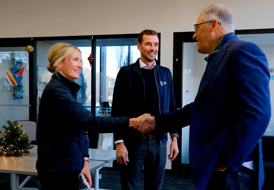 Gina Zejdlik, Atlas Agro director of policy and government relations, left and Dan Holmes, Atlas Agro North America executive director, middle, greet Gov. Jay Inslee last year in Richland.