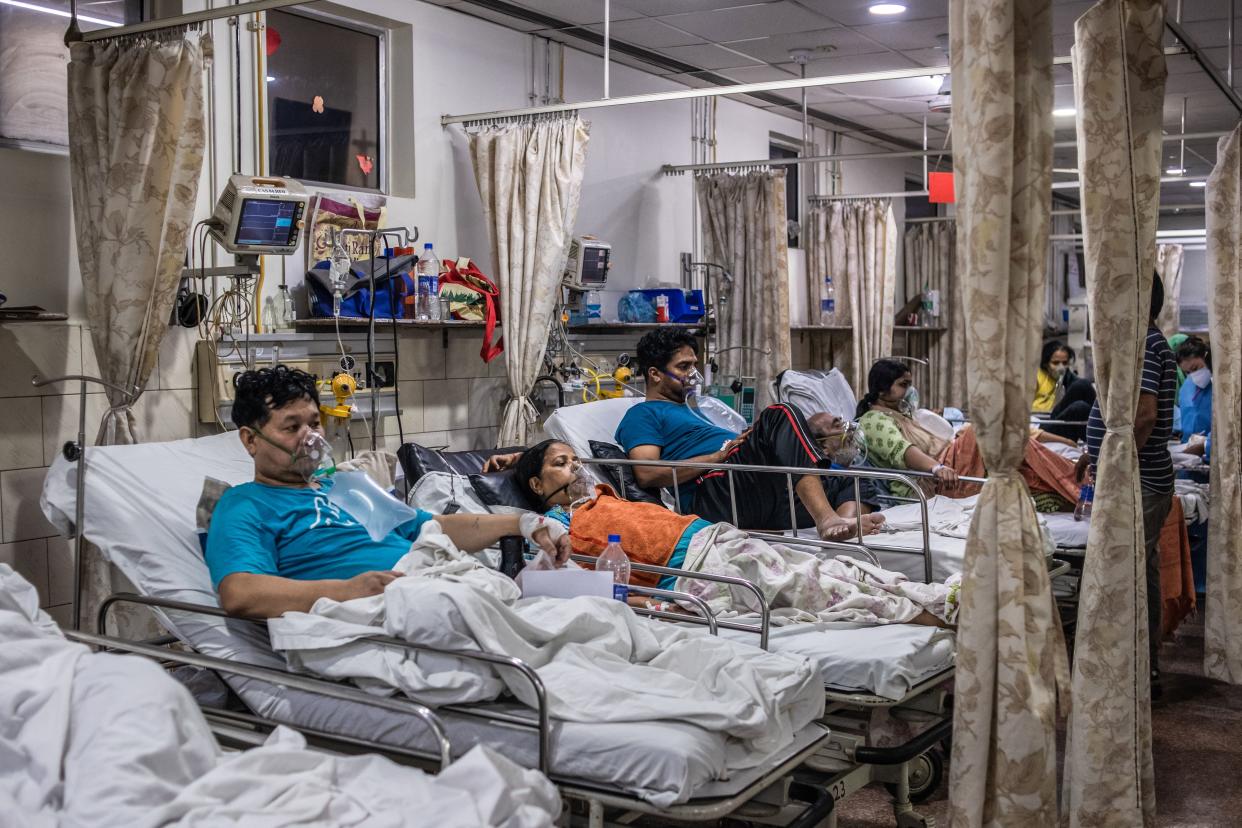 Patients who contracted the coronavirus lie in beds while connected to oxygen supplies inside the emergency ward of a COVID-19 hospital on May 03, 2021, in New Delhi, India.